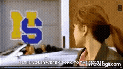 Woman In Front Of Get In Loser Were Going To The Movies Sign GIF
