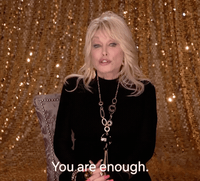 Woman In Front Of Gold Sequined Wall Says You Are Enough GIF