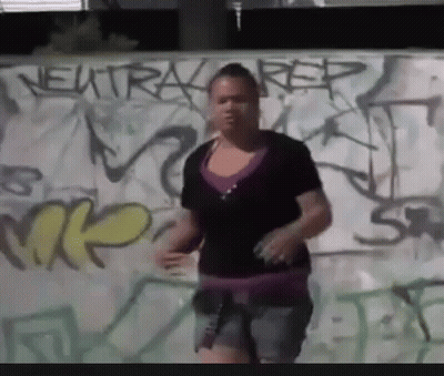 Woman In Front Of Graffiti Wall Saying Neutral Rep GIF