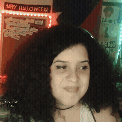 Woman In Front Of Happy Halloween Sign GIF