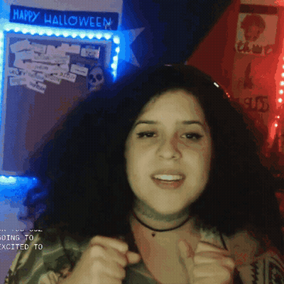 Woman In Front Of Happy Halloween Sign GIF