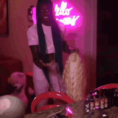 Woman In Front Of Hello Kitty Neon Sign GIF