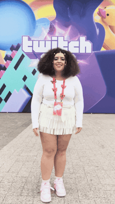 Woman In Front Of Large Twitch Sign GIF