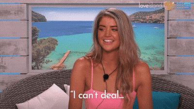 Woman In Front Of Love Island Poster GIF