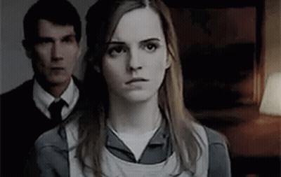 Woman In Front Of Man In Suit And Tie GIF