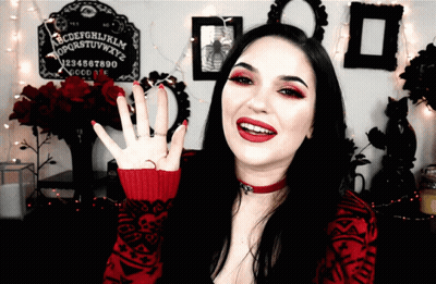 Woman in Front of Ouija Board With Letters