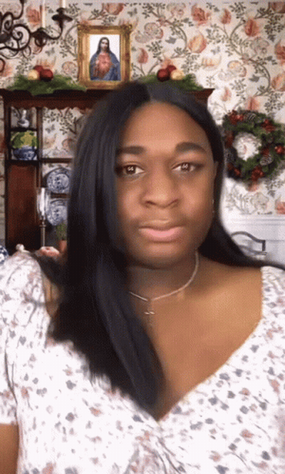 Woman In Front Of Picture Of Jesus GIF