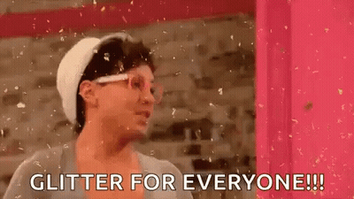 Woman In Front Of Pink Wall Saying Glitter For Everyone GIF