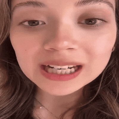 Woman In Front Of Please No Phones Sign GIF