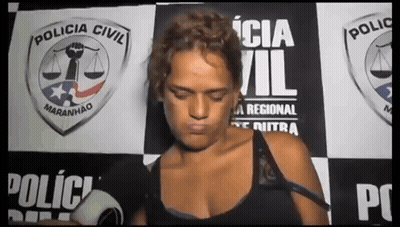 Woman In Front Of Policia Civil Wall GIF