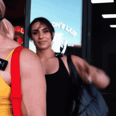 Woman In Front Of Ron's Lair Sign GIF