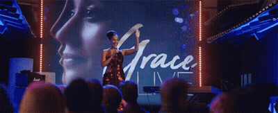 Woman In Front Of Screen Saying Grace Live GIF