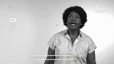 Woman In Front Of Screen Saying MNL GIF