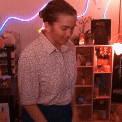 Woman In Front Of Shelf With Book Bullet's GIF