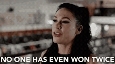 Woman In Front Of Sign Saying No One Has Ever Won Twice GIF
