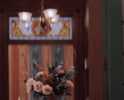 Woman In Front Of Stained Glass Window With Flowers GIF