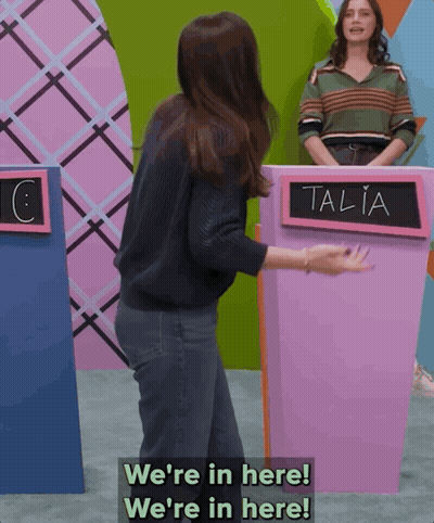 Woman In Front Of Talia Sign GIF