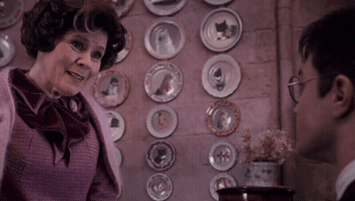 Woman In Front Of Wall Of Plates GIF