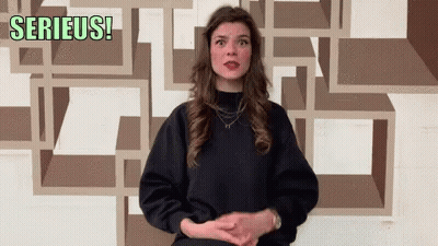 Woman In Front Of Wall Saying Serieus GIF
