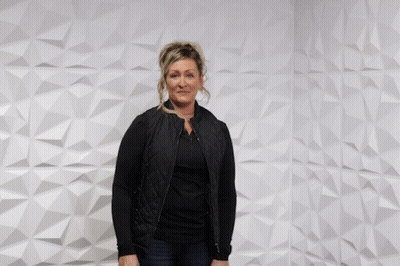 Woman In Front Of Wall Saying You Rock GIF