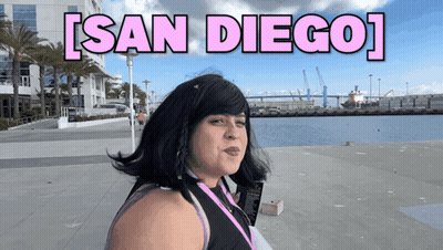 Woman In Front Of Water With San Diego In Pink Letters GIF