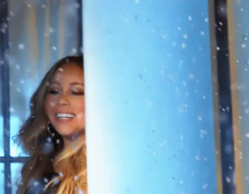 Woman In Front Of Window With Snow Falling GIF