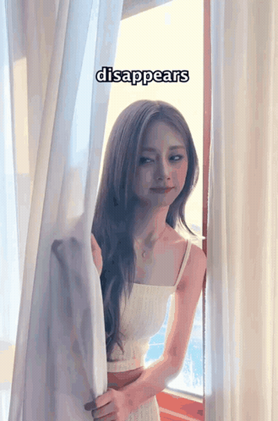 Woman In Front Of Window With Word Disappears GIF
