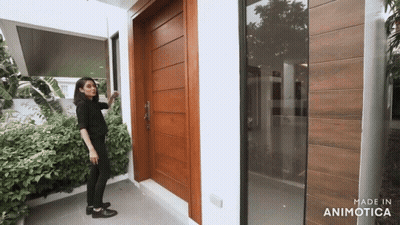 Woman In Front Of Wooden Door GIF
