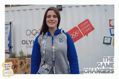 Woman In Front Of Youth Olympic Games Building GIF