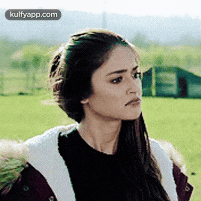 Woman In Fur Coat And Black Sweater In Field GIF