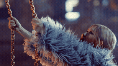 Woman In Fur Coat Holding Chain GIF