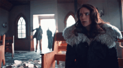 Woman In Fur Coat In Front Of Church GIF