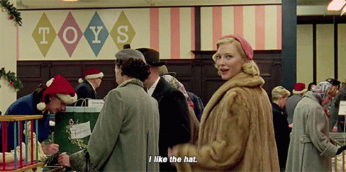 Woman In Fur Coat In Front Of Toys Sign GIF