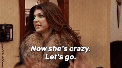 Woman In Fur Coat Standing In Front Of Telephone GIF