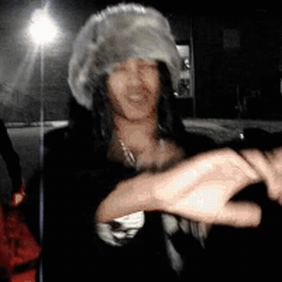 Woman In Fur Hat And Necklace Dancing GIF