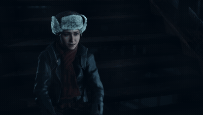 Woman In Fur Hat And Scarf Smiling In Dark GIF