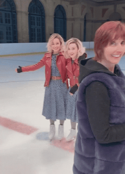 Woman In Fur Vest With Two Women On Ice GIF