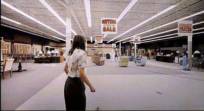 Woman In Furniture Store With Metro Section Sale Sign GIF