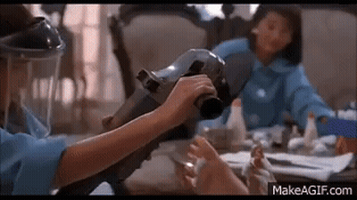 Woman In Gas Mask Holding Vacuum Cleaner GIF
