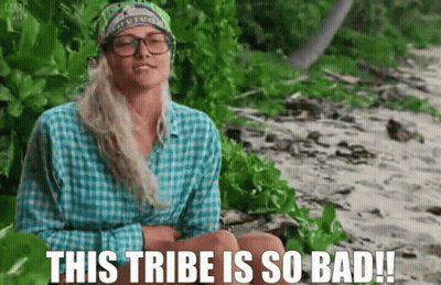 Woman In Glasses And Bandana Sitting On Beach Saying This Tribe Is So Bad GIF