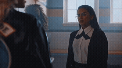 Woman In Glasses And Black Jacket Standing By Window GIF