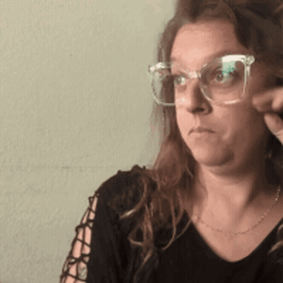 Woman In Glasses And Black Shirt Serious GIF