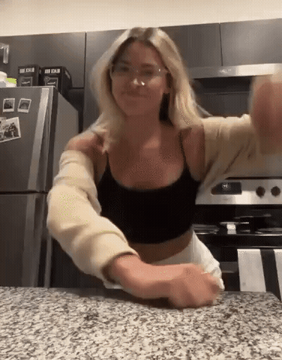 Woman In Glasses And Black Tank Top Standing In Kitchen GIF