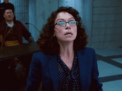 Woman In Glasses And Blue Jacket Looking Up GIF