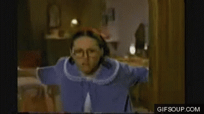 Woman in Glasses and Blue Robe Standing in Room