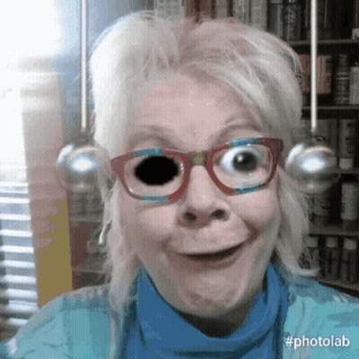 Woman In Glasses And Blue Shirt With Black Eye GIF