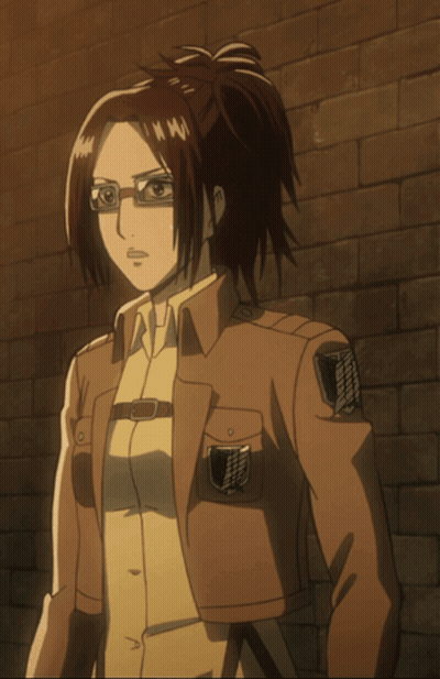 Woman In Glasses And Brown Jacket In Front Of Brick Wall GIF