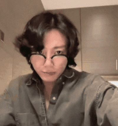 Woman In Glasses And Denim Shirt Taking Selfie GIF