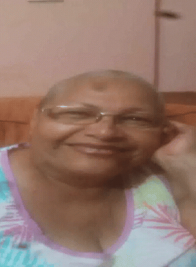Woman In Glasses And Floral Shirt Smiling GIF