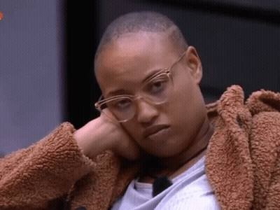 Woman In Glasses And Fur Coat With Hand On Face GIF
